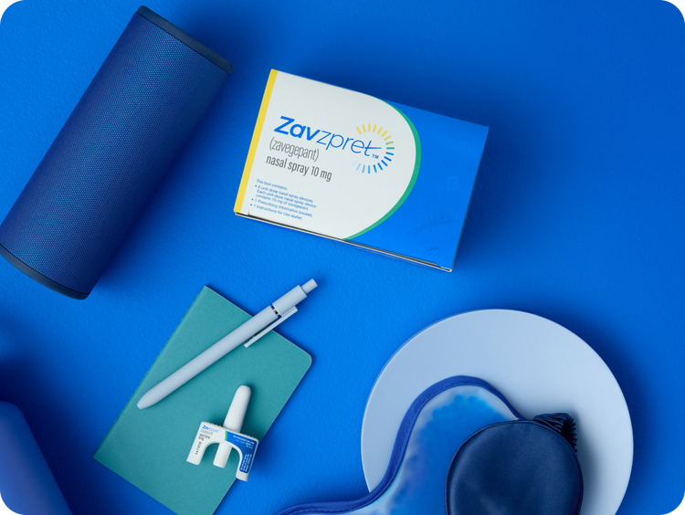 ZAVZPRET™ (zavegepant) nasal spray 10mg and pen laying on a table